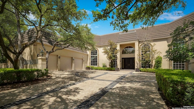 mediterranean / spanish house featuring a garage