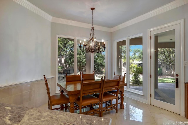 dining area with light tile patterned floors, a notable chandelier, and ornamental molding