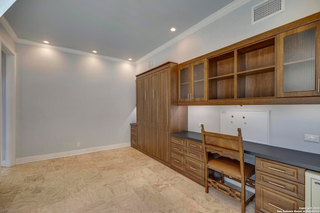 home office with built in desk and ornamental molding