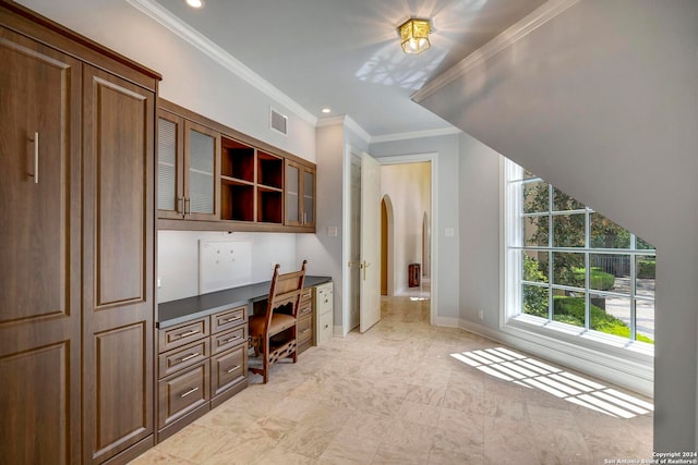 office area featuring crown molding and built in desk