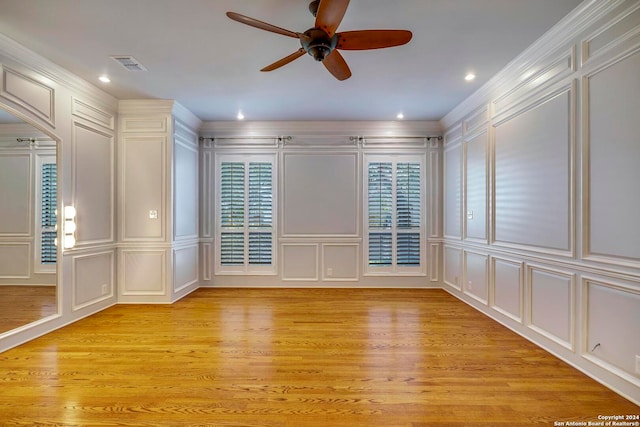 spare room featuring crown molding, ceiling fan, and light hardwood / wood-style floors