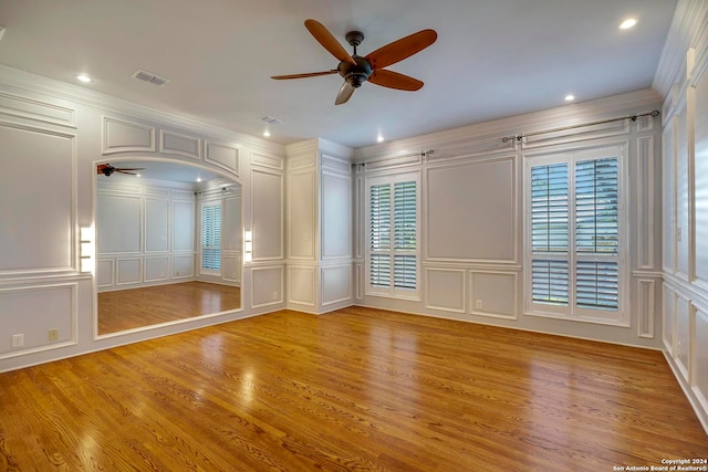 spare room with crown molding, light hardwood / wood-style flooring, and ceiling fan