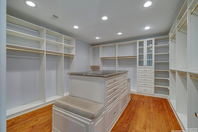 spacious closet with light hardwood / wood-style flooring