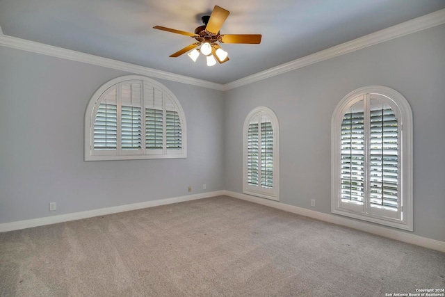 carpeted empty room with crown molding and ceiling fan