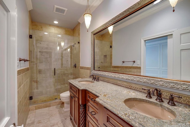 bathroom with toilet, tile patterned floors, vanity, tile walls, and a shower with shower door