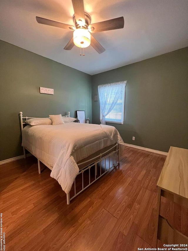 bedroom featuring hardwood / wood-style floors and ceiling fan