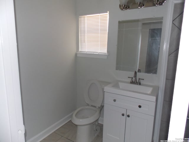 bathroom with vanity, toilet, and tile patterned floors