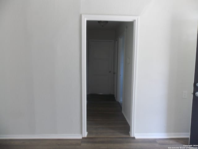 corridor with dark wood-type flooring