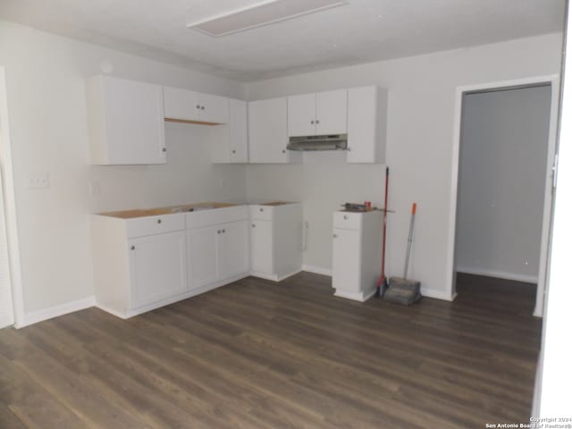 kitchen featuring dark wood-type flooring and white cabinets