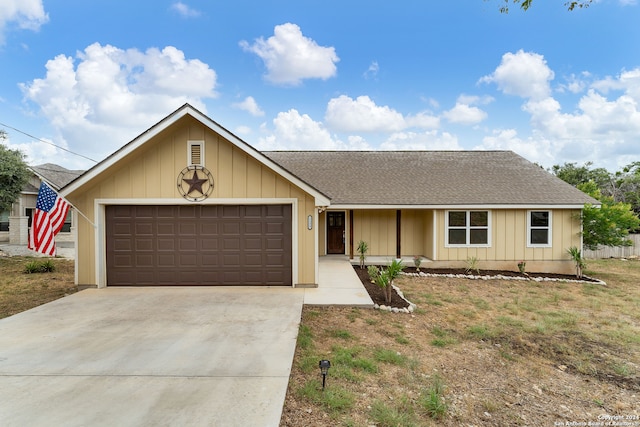 single story home with a garage and a front lawn