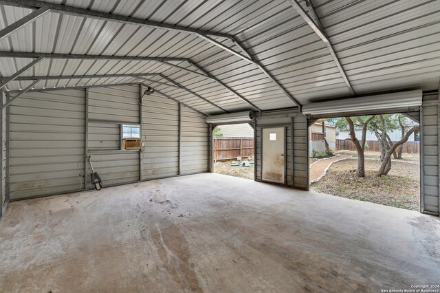 garage with a carport and cooling unit