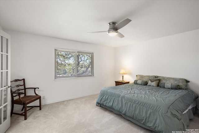 bedroom with ceiling fan and light carpet