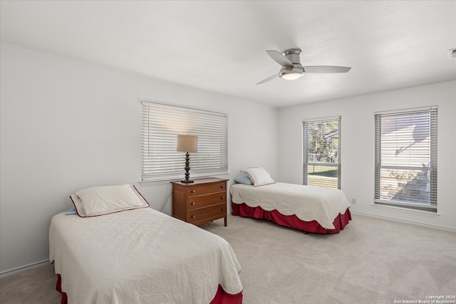 carpeted bedroom featuring ceiling fan