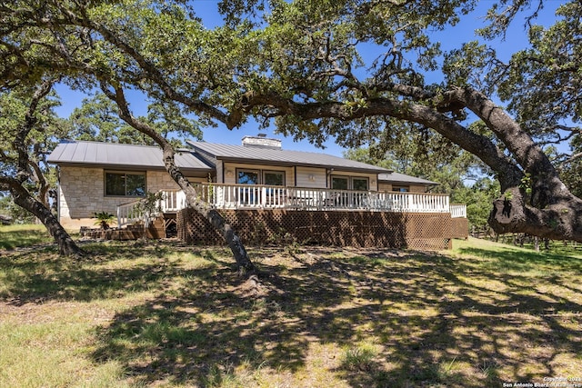 view of front of home featuring a front lawn and a deck