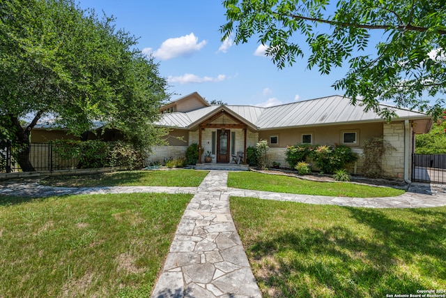 single story home featuring a front lawn and french doors