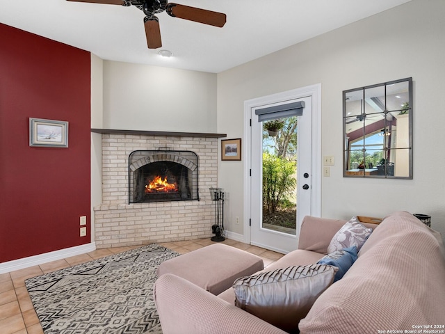 tiled living room featuring a brick fireplace and ceiling fan