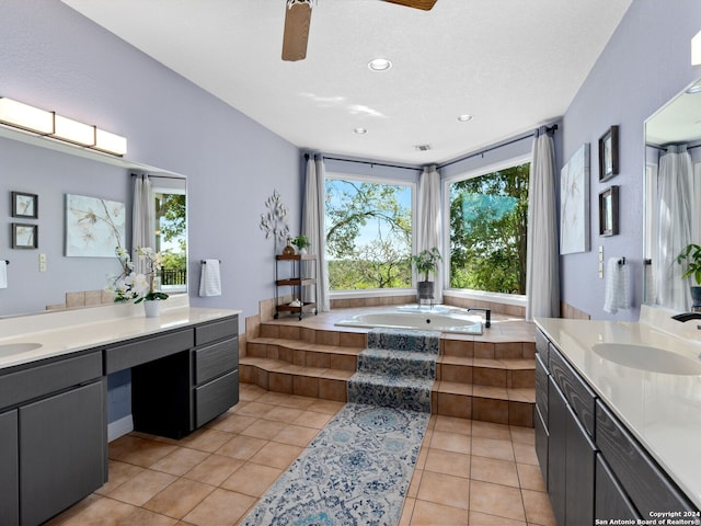 bathroom featuring tile patterned flooring, vanity, tiled bath, and ceiling fan