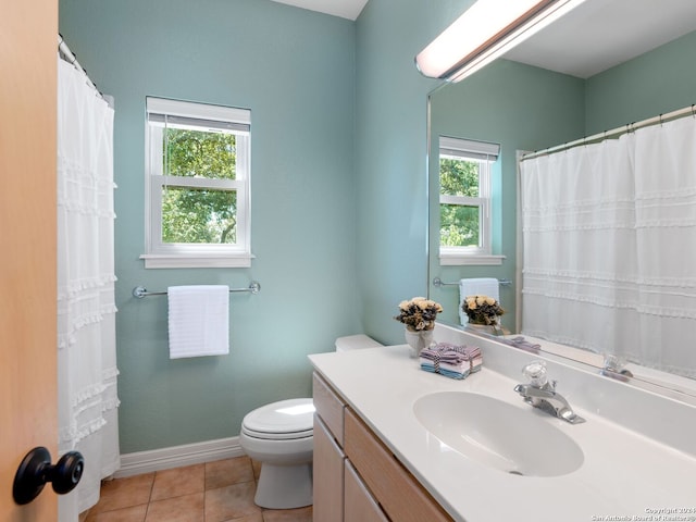 bathroom featuring vanity, tile patterned floors, and toilet