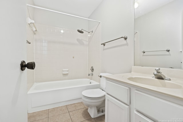 full bathroom with tile patterned flooring, toilet, tiled shower / bath, and vanity