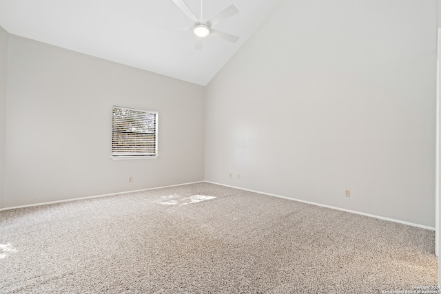 carpeted spare room with high vaulted ceiling and ceiling fan