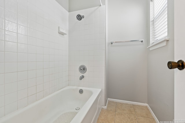 bathroom featuring tiled shower / bath combo and tile patterned floors