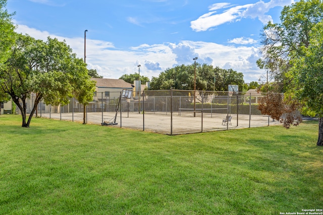 view of sport court featuring a lawn