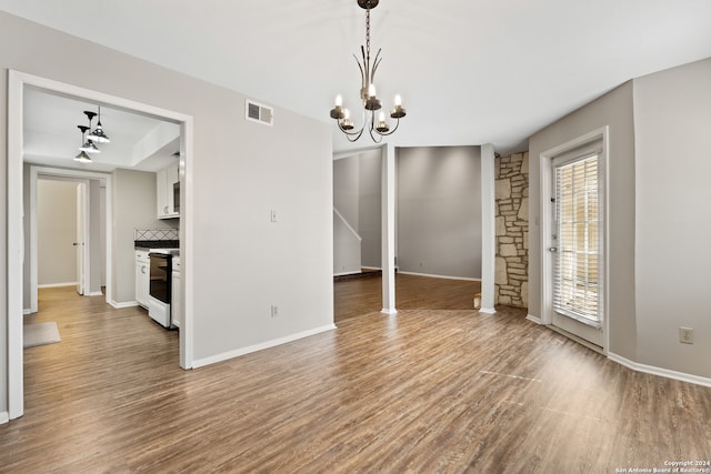 interior space with hardwood / wood-style flooring and a chandelier