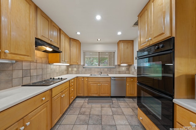 kitchen featuring light tile patterned floors, stainless steel appliances, decorative backsplash, and sink