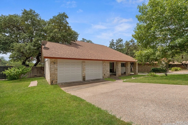 view of front of home with a garage and a front lawn