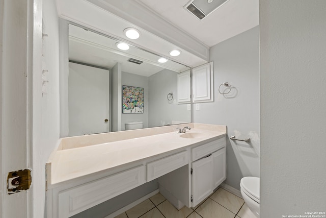 bathroom with vanity, toilet, and tile patterned floors