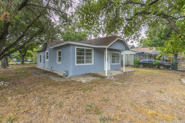 view of front of home with fence and stucco siding