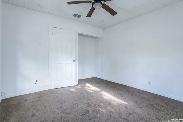 carpeted empty room with ceiling fan