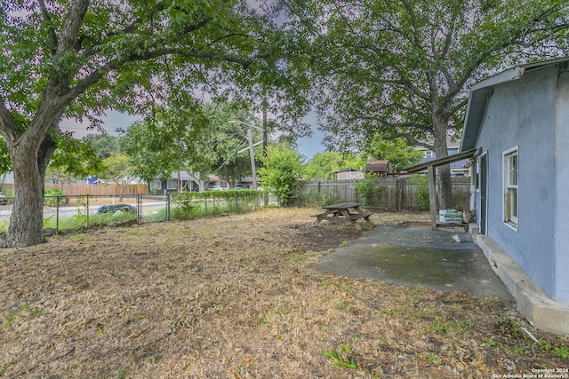 view of yard featuring a patio area and a fenced backyard