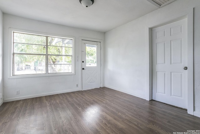 unfurnished room featuring baseboards and wood finished floors