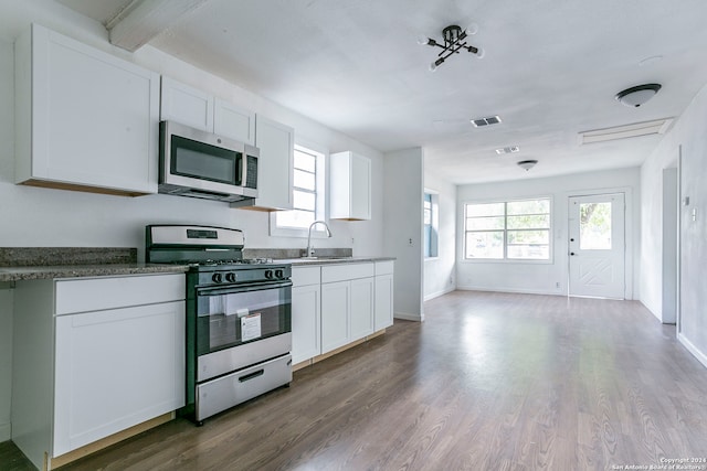 kitchen featuring stainless steel appliances, sink, hardwood / wood-style floors, and white cabinetry