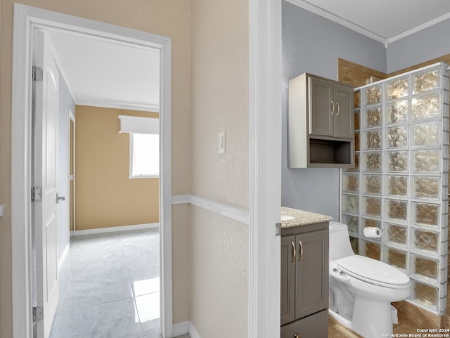 bathroom featuring ornamental molding, vanity, and toilet