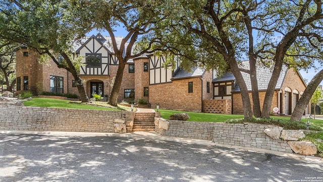 tudor house featuring a front lawn