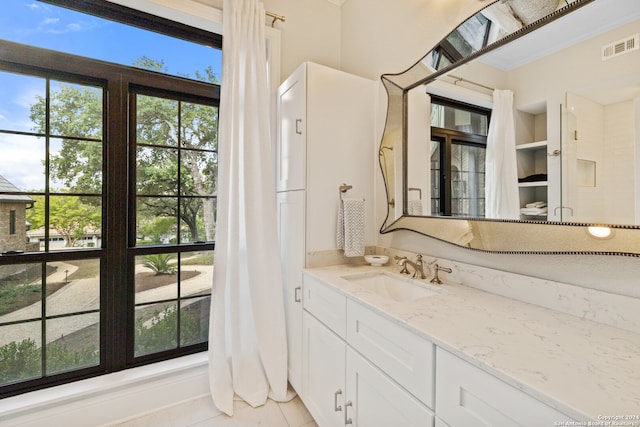 bathroom featuring tile patterned flooring and vanity