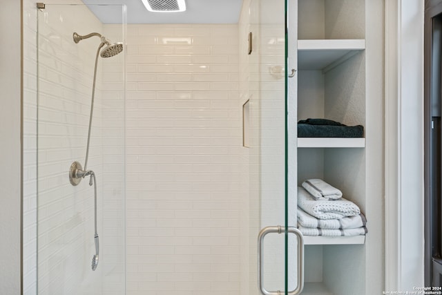 bathroom with a shower with shower door