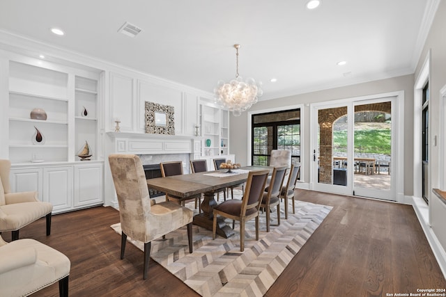 dining space with an inviting chandelier, ornamental molding, dark hardwood / wood-style floors, and built in features