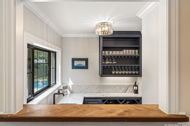 interior space featuring an inviting chandelier, ornamental molding, and sink