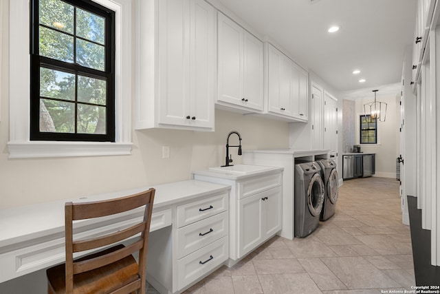 washroom featuring an inviting chandelier, cabinets, sink, and independent washer and dryer