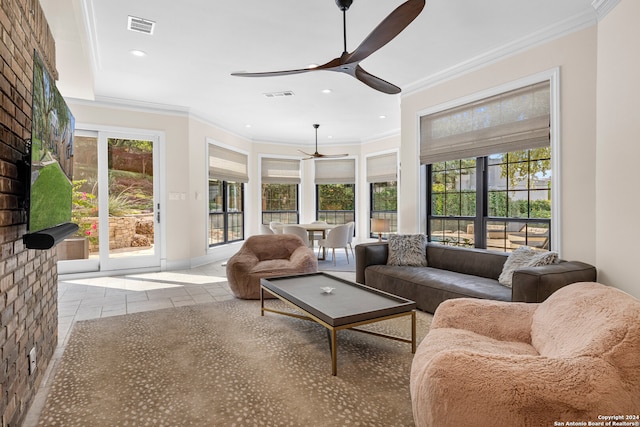 tiled living room with ceiling fan and crown molding