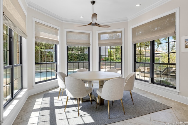 dining space with ornamental molding and ceiling fan