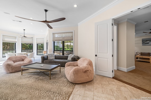 carpeted living room featuring ceiling fan and crown molding