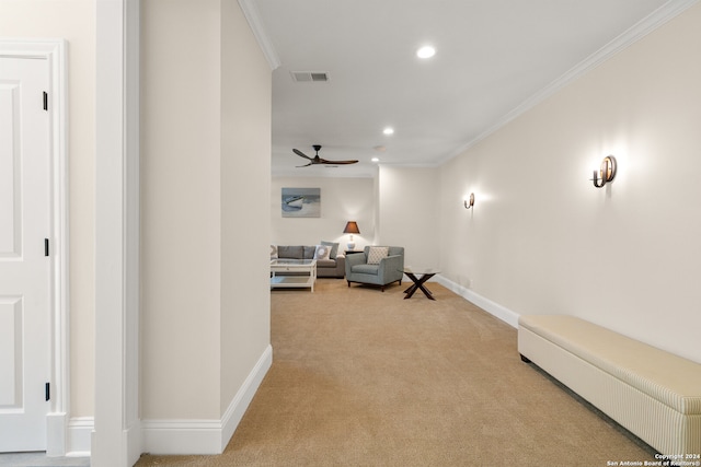 interior space featuring ornamental molding, carpet, and ceiling fan