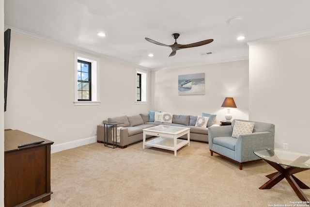 carpeted living room with ceiling fan and crown molding