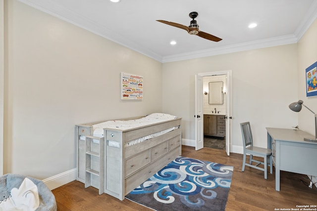 bedroom featuring ornamental molding, dark hardwood / wood-style flooring, ceiling fan, and ensuite bath