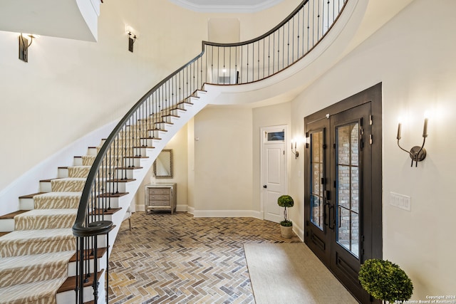 foyer entrance featuring french doors and a high ceiling