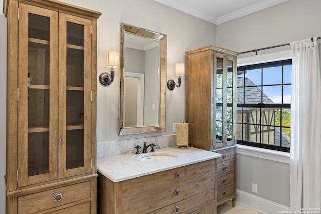 bathroom with vanity, ornamental molding, and tile patterned floors